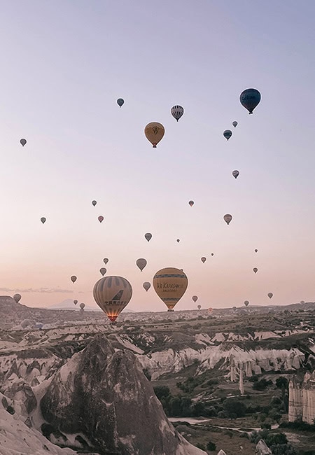 Hot air balloons float above the landscape in Cappadocia Turkey - Passports and Photographs Travel Blog